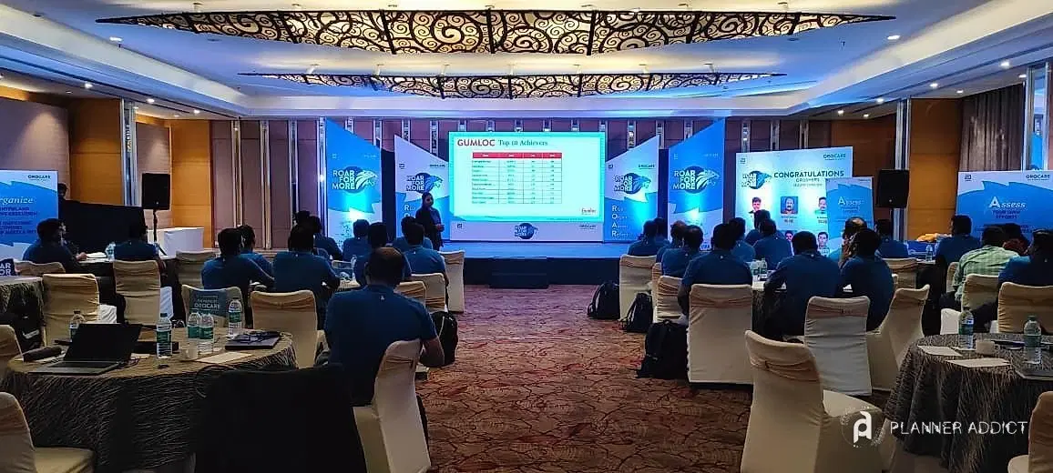 Awards session in a conference hall with a large screen