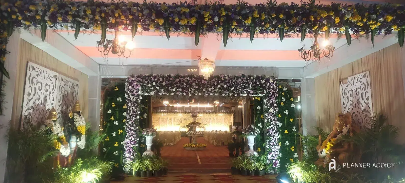 Hall entrance with a flower frame, statues and garden planters