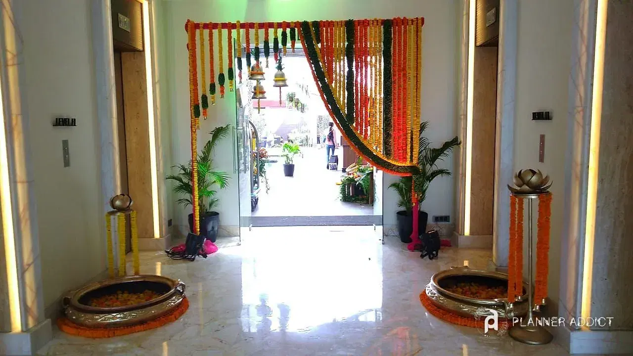 Marigold doorway with brass urlis and lamps