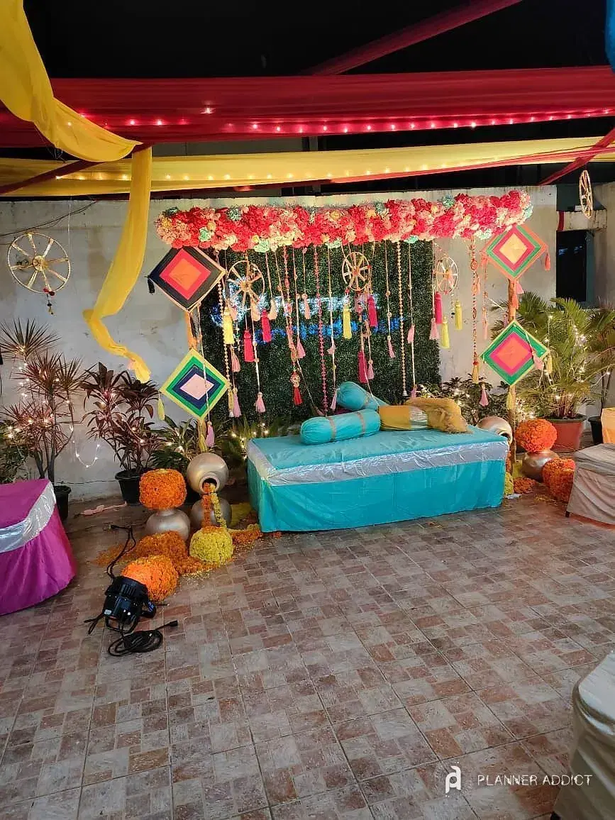 Seating under flower garlands with kite decorations
