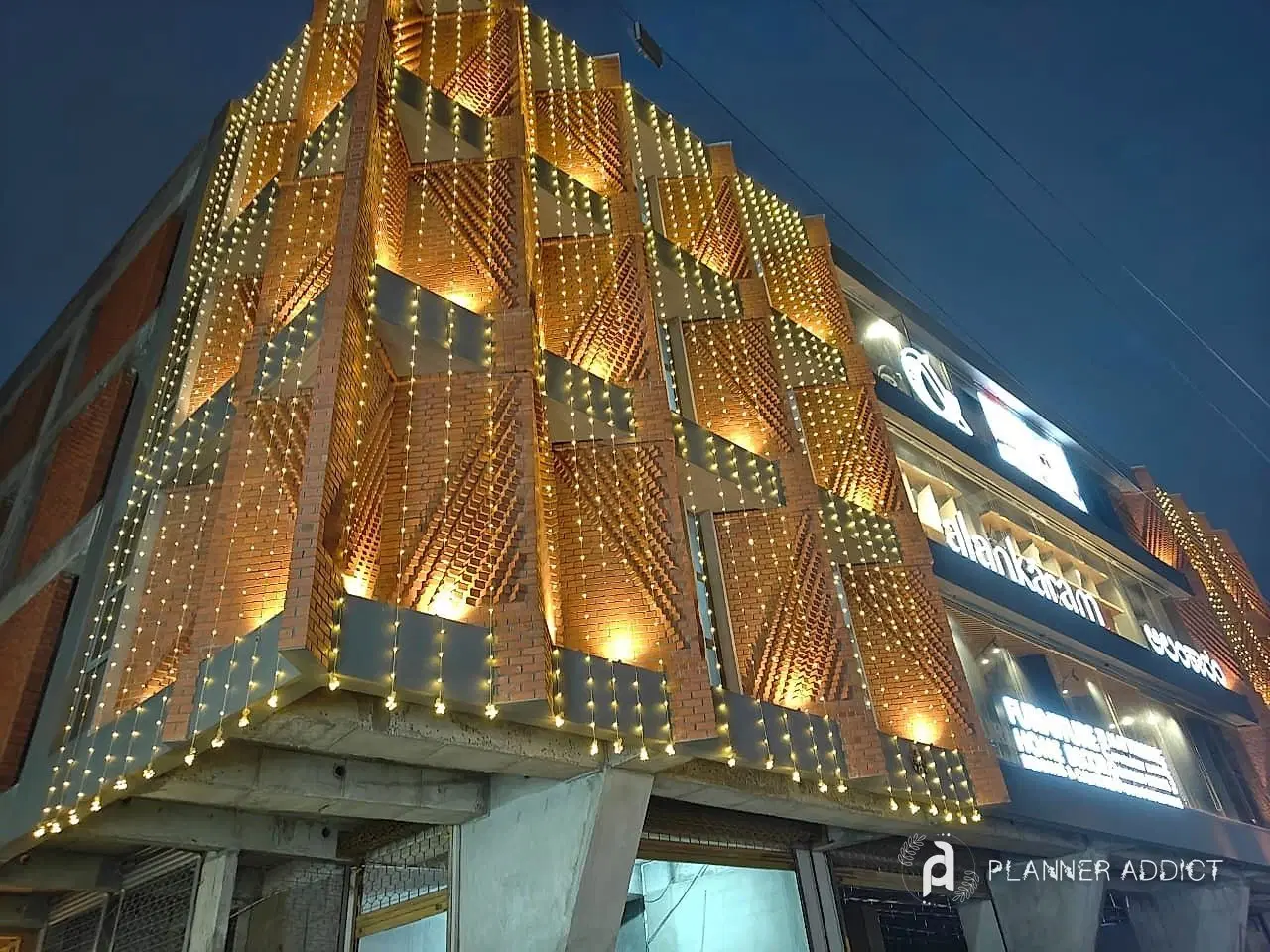 Close view of a building front lit with warm serial lights