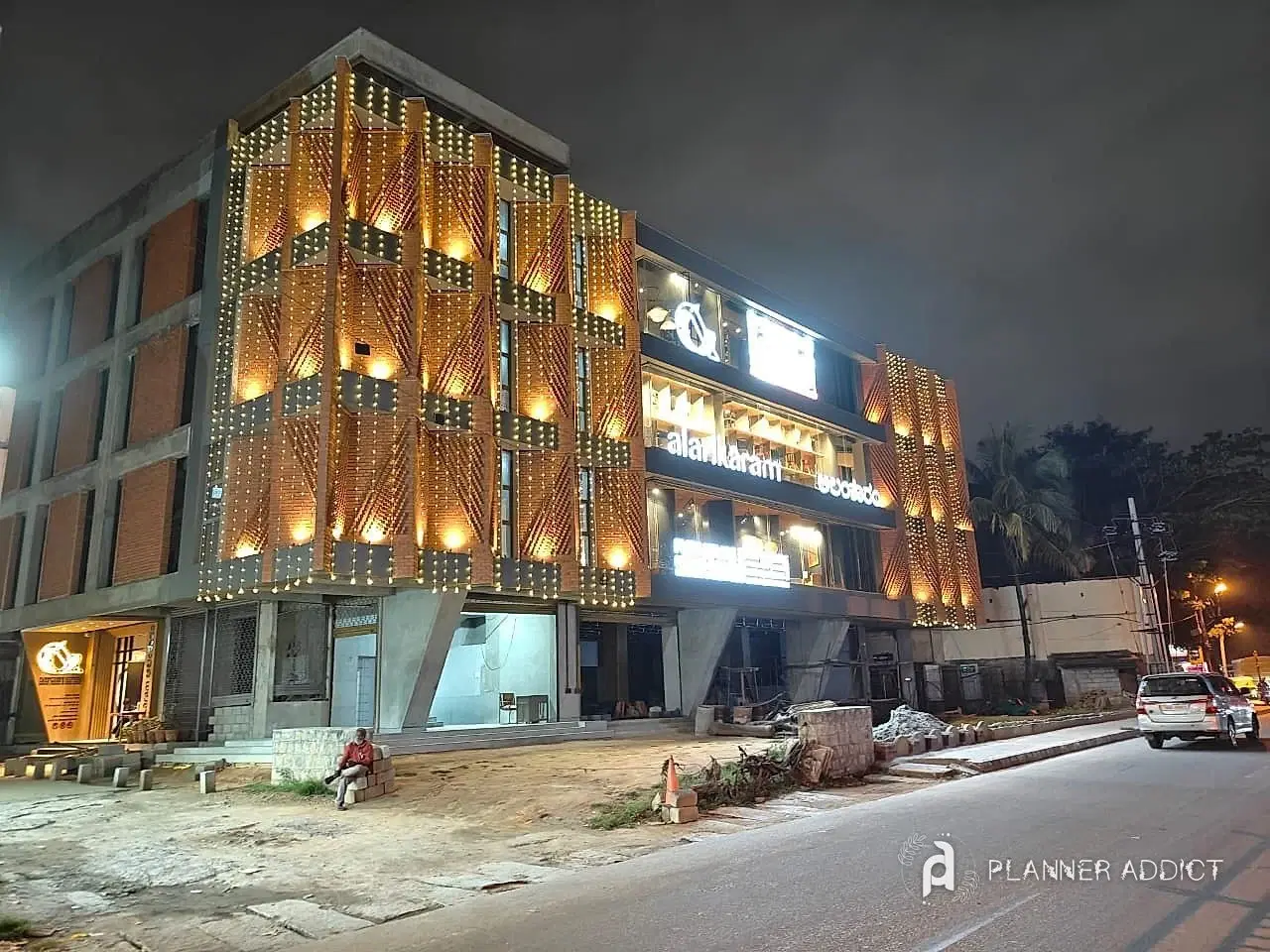 Building front covered in warm serial lights at night