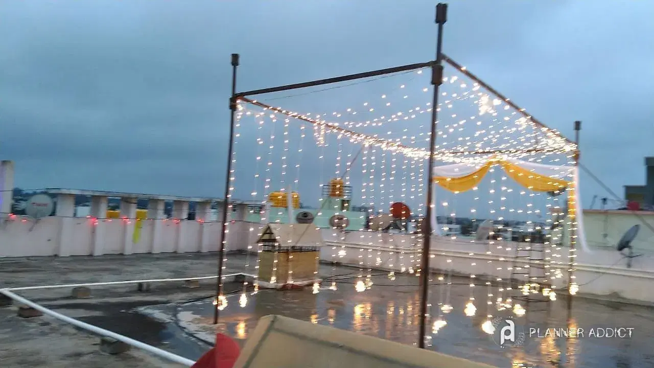 Rooftop frame hung with bulb strings