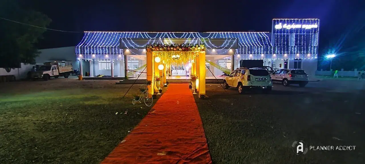 Venue front covered in blue and white serial lights, with a lit entrance