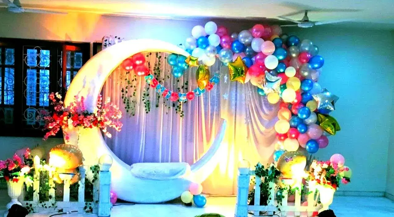 Naming ceremony stage with a decorated cradle
