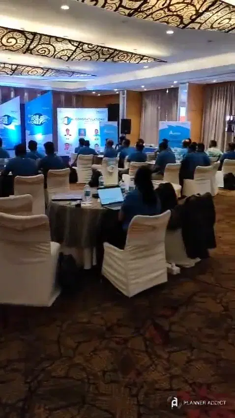 Registration desk, standees and round tables set up in a hotel conference hall