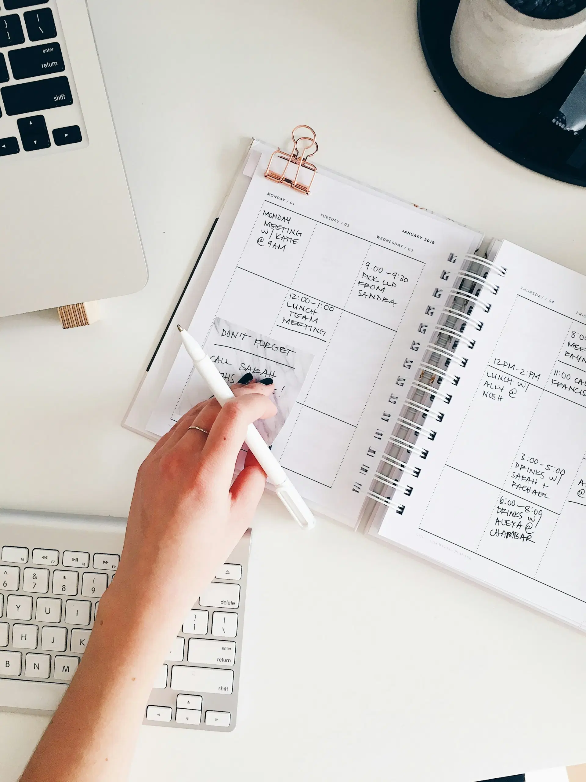 Notebook with a handwritten plan beside a laptop
