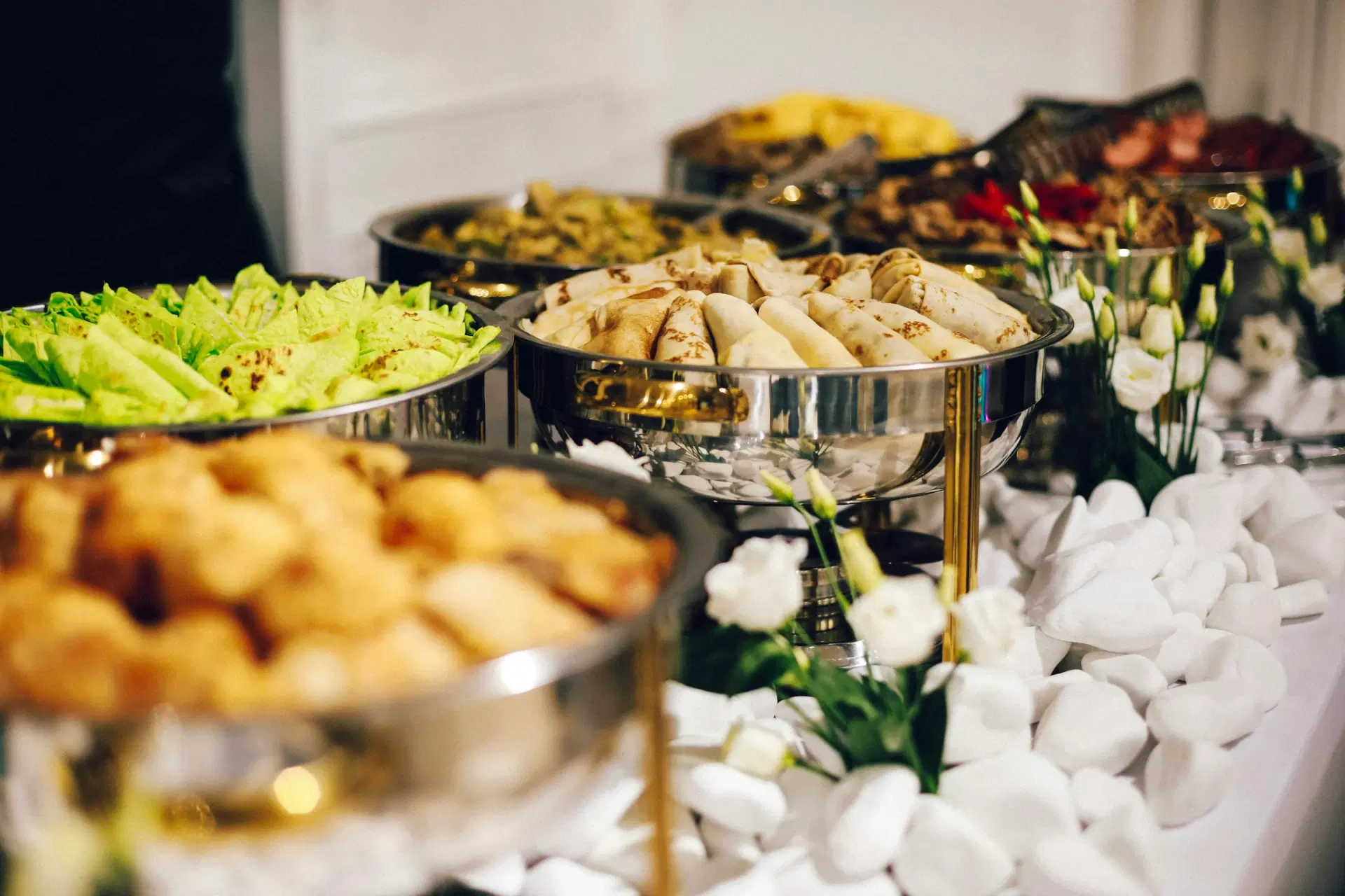 Buffet counter with silver chafing dishes of food
